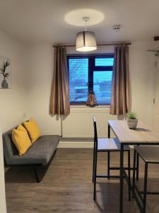 a living room with a couch and a table at The mill wheel in Hartshorne