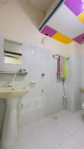 a bathroom with a sink and a shower at Hotel Jom Jom International in Dhaka