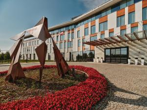 a building with a bunch of flowers in front of it at GrandHotel Tiffi in Iława +47 photos