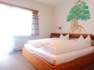 a bedroom with a large bed with a wooden frame at Hotel Acla Filli in Zernez