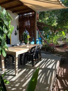 a wooden table and chairs on a patio at Vila Coco Dendê - Algodões in Marau