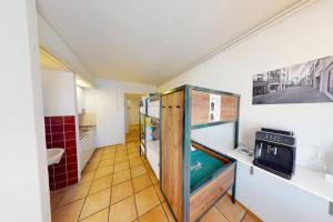 a small room with a kitchen with a sink at Solution-Grischun - Zentral - Etagenbett - Smart TV - Kaffe&Tee in Chur