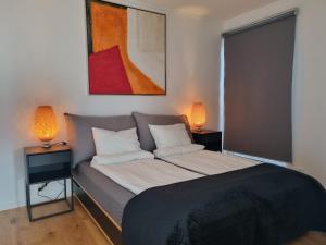 a bedroom with a bed with two lamps on it at Lommedalen Panorama 55m2 in Bærums Verk +22 photos