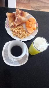 two plates of food with toast and a cup of coffee at Villalba Boutique Hotel in Valledupar