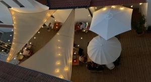 an overhead view of two umbrellas in a building with lights at Hotel Desatero in Mikulov