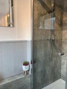 a shower with a glass door in a bathroom at Fabulous flat in the fantastic location of Gosforth in Gosforth