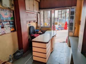 a train room with a desk and a window at Hotel Annapurna in Bhuj