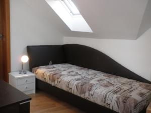 a bedroom with a bed with a black headboard at Apartment Paradise Michalská in Prague