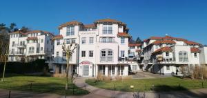 a large white building with a lot of windows at Sun Island in Baabe