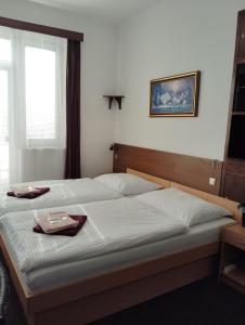 a bedroom with a bed with a tray on it at Hotel Lux in České Budějovice