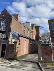 an old brick building with a gate in front of it at East Cliff in Preston