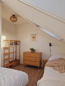 a bedroom with two beds and a skylight at Appartement op topligging! in Cadzand