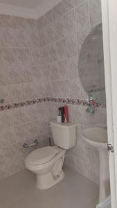 a bathroom with a toilet and a sink at casa para festival vallenato in Valledupar