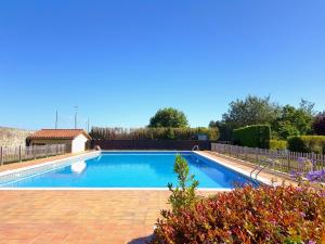 a swimming pool in a yard with a fence at Camping L´Amuravela in Cudillero