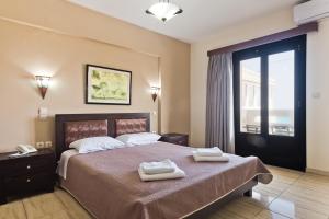 Postel nebo postele na pokoji v ubytování Arkasa Bay Hotel