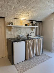 a kitchen with a sink and a counter top at MIA HOUSE APARTMENT in Monopoli