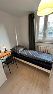 a large bed in a room with a window at Rooms in Warsaw - G5 in Warsaw