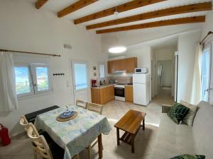 a living room with a table and a kitchen at Vaia Villas in Mochlos