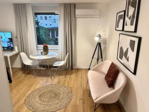 a living room with a table and a chair at Sweet Studio in the City Center Area in Ljubljana