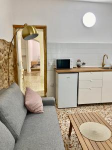a living room with a couch and a kitchen at La Santa in Almagro +52 photos