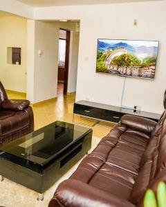 a living room with a couch and a coffee table at Sofitel Executive 4 bedrooms Milimani in Kisumu