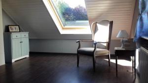 a room with a window and a chair and a desk at Ferienwohnung-Ostseestrand-in-Stein-bei-Laboe in Stein