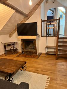 a living room with a tv and a fireplace at Appartement Aéroport Orly in Athis-Mons