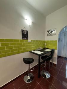 a bar with two chairs and a table in a room at Smith House in Budapest