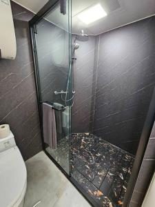 a bathroom with a glass shower with a toilet at Forest Capsule in Uddevalla