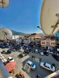 a city with cars parked in a parking lot at Lovely flat , full furnished with free parking in Prizren