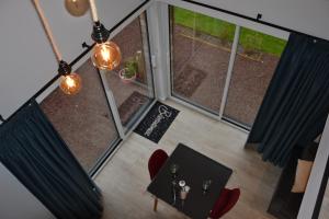 an overhead view of a dining room table and chairs at La Dépendance d'En Face in Huppy +15 photos