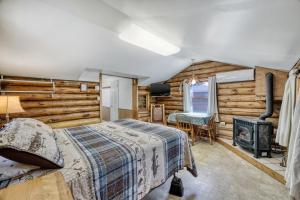 a bedroom with a bed and a fireplace at Edgewater Resort in Iron Mountain