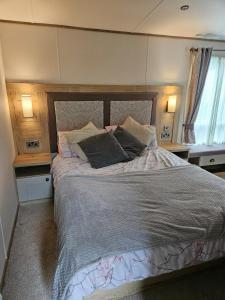 a bed in a bedroom with two pillows on it at Roadnights Retreat in Heysham