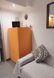 a room with a couch and a yellow cabinet at Nido al Mare in Bonassola