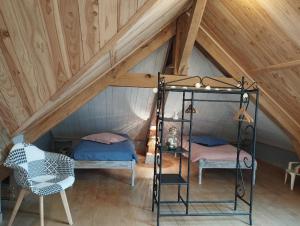 a room with two beds in a attic at Au Pans de Bois. Repos et Détente in Auxon