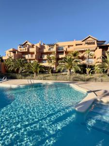 a large swimming pool in front of a building at Alegría - Mar Menor Golf Resort in Torre-Pacheco