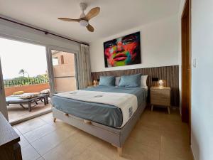 a bedroom with a bed with a painting on the wall at Alegría - Mar Menor Golf Resort in Torre-Pacheco
