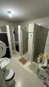 a bathroom with a toilet and a shower and a sink at Nomads Hostel Multicultural & Coworking in Salvador