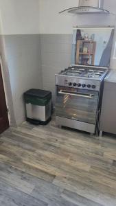 a kitchen with a stove and a trash can at Le moulin in Outrepont +11 photos