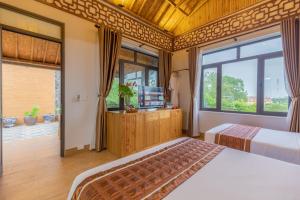 Ein Bett oder Betten in einem Zimmer der Unterkunft Tam Coc Serenity Hotel & Bungalow