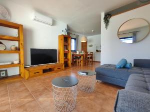 a living room with a couch and a tv at Villa Valperal, en Lanzarote in Playa Blanca