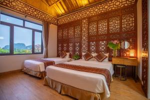 Ein Bett oder Betten in einem Zimmer der Unterkunft Tam Coc Serenity Hotel & Bungalow