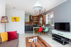 a living room with a couch and a table at City Center - Granary Island by Apartmore in Gdańsk