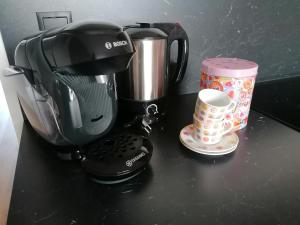 a coffee maker sitting on a counter next to a cup at #HeimatLiebe in Imst