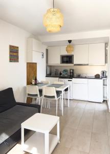 a living room and kitchen with a couch and a table at Casa Hugo in Costa Calma