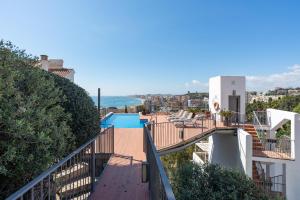 a balcony of a house with a swimming pool at Modern townhouse with stunning view in Fuengirola