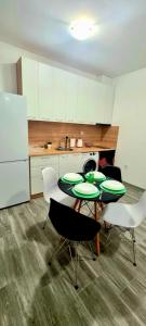 a kitchen with two tables and chairs and a refrigerator at Lazy loft in Sofia