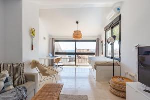 a living room with a bed and a couch at Modern townhouse with stunning view in Fuengirola