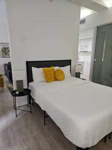 克利夫蘭的住宿－629 Lofts 802 - A KCM Property，一张大白色的床,上面有两个黄色的枕头