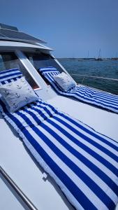 two beds on the back of a boat at Tarasmaki - Boat House in Ilha da Culatra